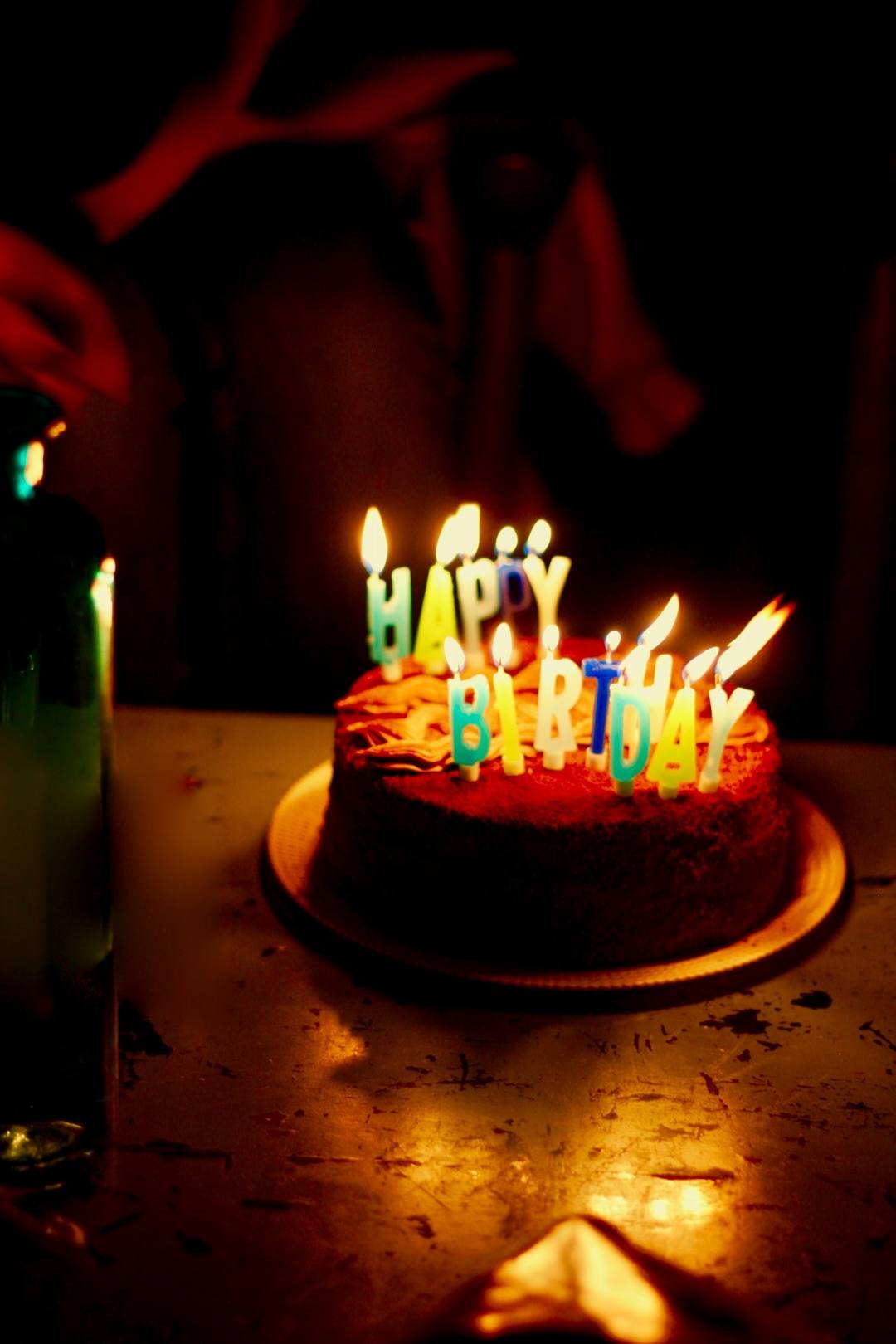 A cake with lit candles, unedited